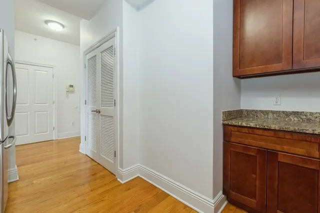 a view of a kitchen with wooden floor and cabinets
