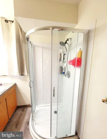 a bathroom with a granite countertop sink a toilet and shower