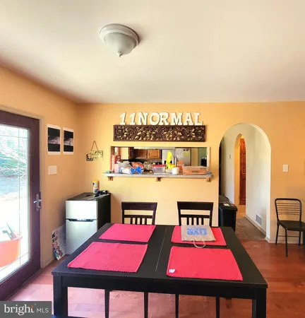 a living room with furniture pool table and a window
