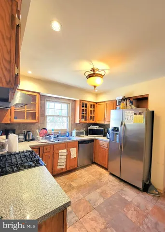 a kitchen with stainless steel appliances granite countertop a sink counter space and stainless steel appliances