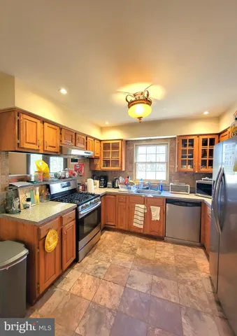 a kitchen with stainless steel appliances granite countertop a stove sink and cabinets