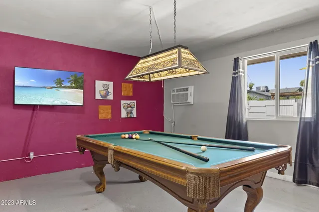 a room with pool table and a flat screen tv