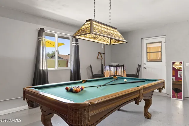 an entryway with bed and painting on the wall