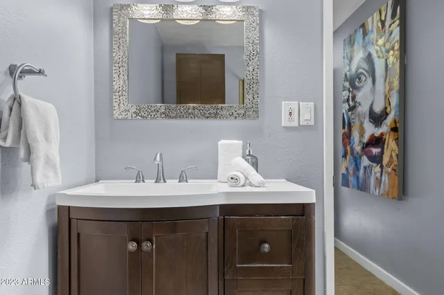a bathroom with a sink and a mirror