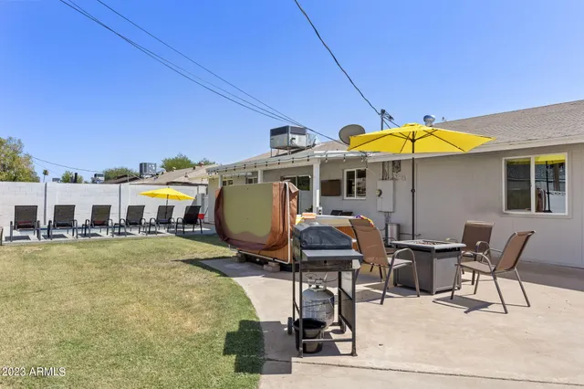 a view of a patio with table and chairs under an umbrella