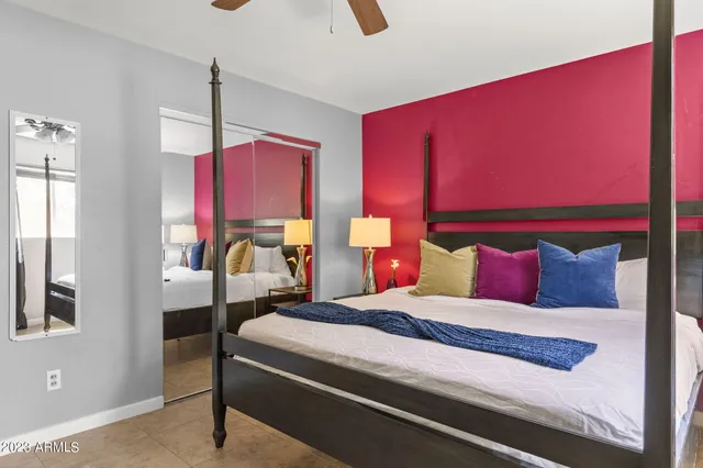 a bedroom with a bed and lamp