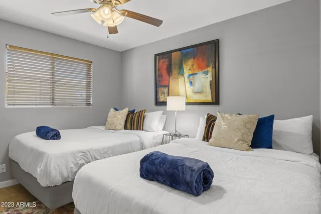 a bedroom with a bed and a table in it