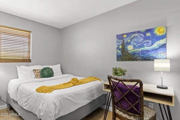 a bedroom with a large bed and a window