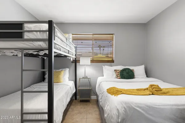 a bathroom with a granite countertop sink a toilet and a mirror