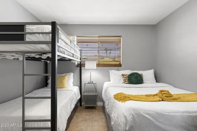 a bathroom with a granite countertop sink a toilet and a mirror