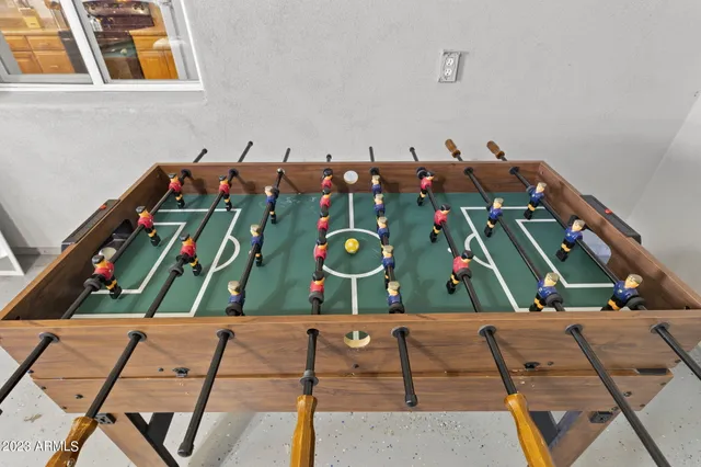 a room with pool table and a flat screen tv