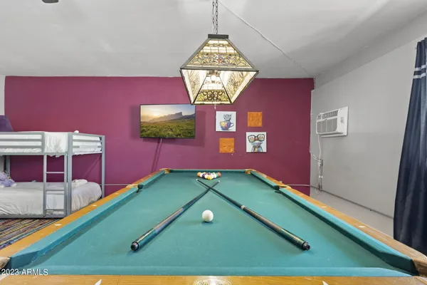 a room with a table and a chandelier