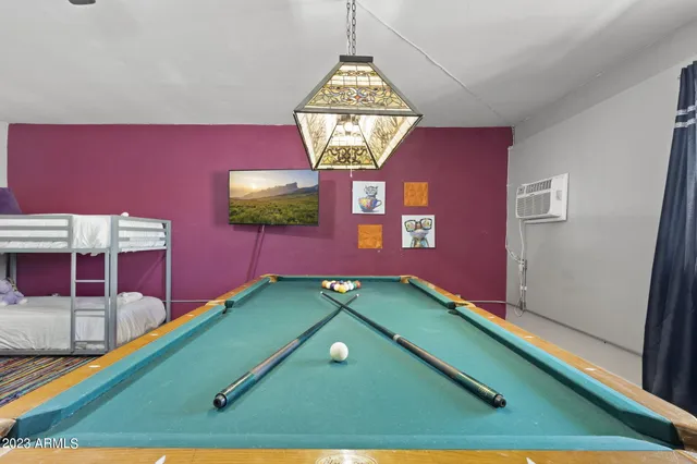 a room with a table and a chandelier