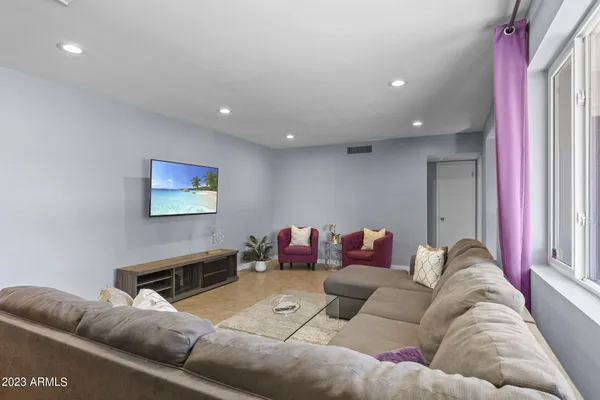 a living room with furniture and a flat screen tv
