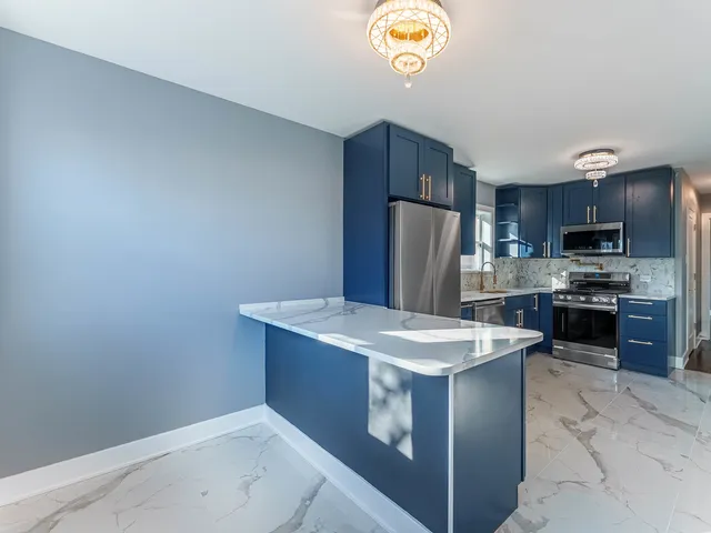 a kitchen with a sink a stove a refrigerator and a microwave