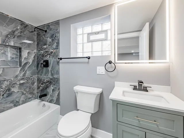 a bathroom with a sink toilet and shower