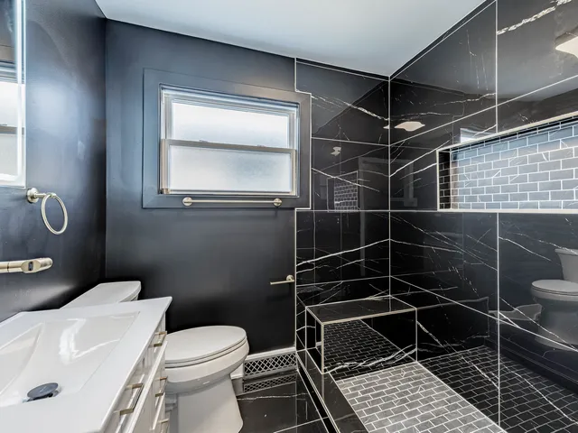 a bathroom with a toilet and a shower