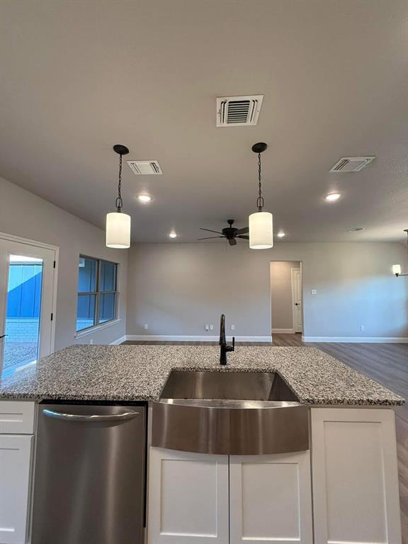 1015 Bluestem Weatherford, TX 76087 - Photo 4 of 11 a kitchen with a sink and chandelier