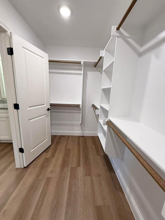 1015 Bluestem Weatherford, TX 76087 - Photo 7 of 11 a view of a kitchen with wooden floor and electronic appliances