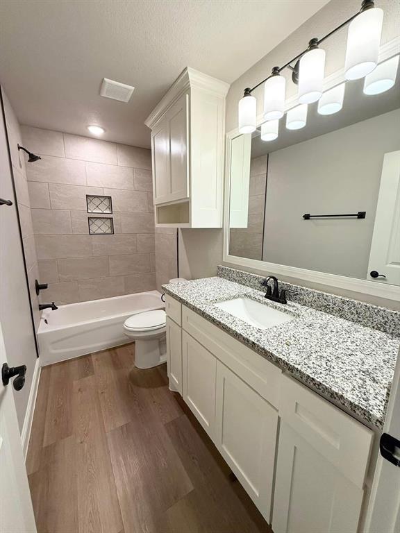 1015 Bluestem Weatherford, TX 76087 - Photo 10 of 11 a bathroom with a granite countertop sink mirror vanity and toilet