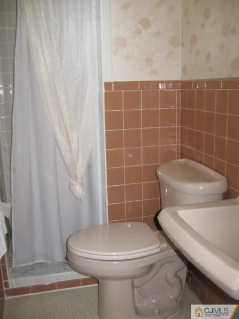 10 Glen Gary Road Middlesex, NJ 08846 - Photo 13 of 24 a white toilet sitting next to a bathroom sink