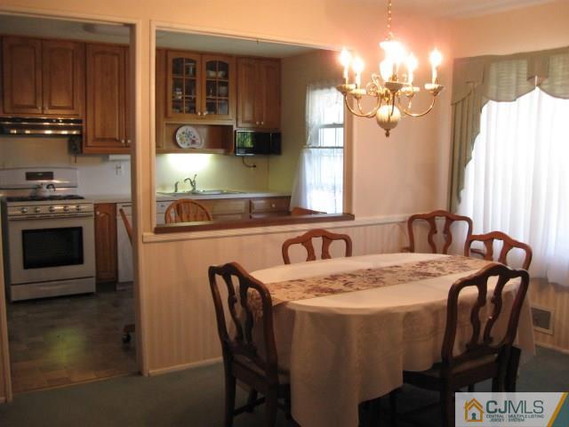 10 Glen Gary Road Middlesex, NJ 08846 - Photo 6 of 24 a dining table with chairs and kitchen view