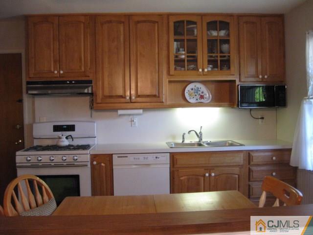10 Glen Gary Road Middlesex, NJ 08846 - Photo 8 of 24 a kitchen with stainless steel appliances granite countertop a stove and a microwave
