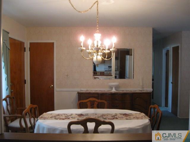 10 Glen Gary Road Middlesex, NJ 08846 - Photo 10 of 24 a bedroom with a bed and a chandelier