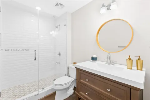 a bathroom with a sink a toilet and a mirror
