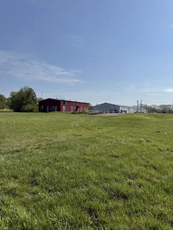 a view of a field with an ocean view