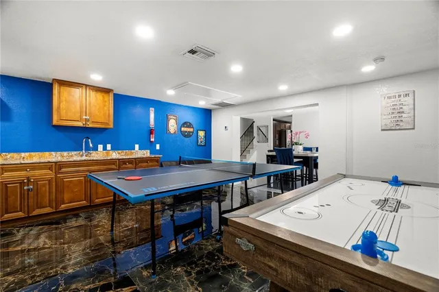 a room with furniture pool table and windows