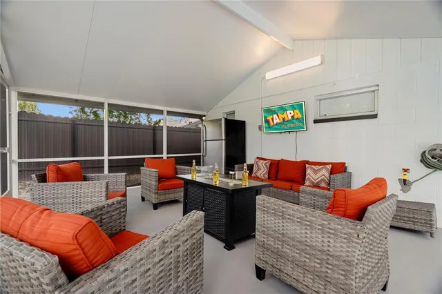 a living room with furniture a flat screen tv and a table