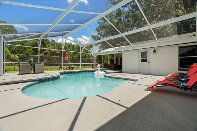 a view of a backyard with a table and chair