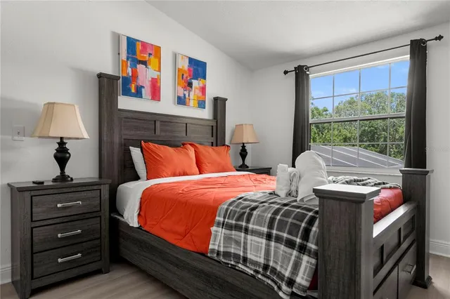 a bedroom with a bed and a window