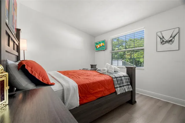 a bed sitting in a bedroom next to a window