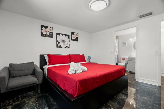 a bedroom with a bed and a couch