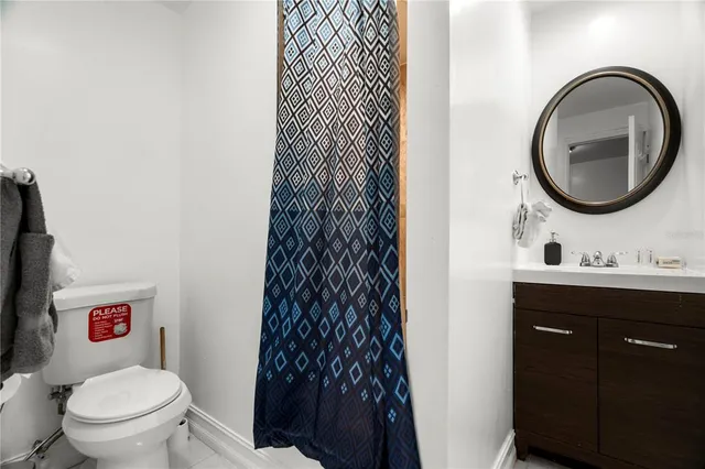 a bathroom with a toilet a sink and a mirror