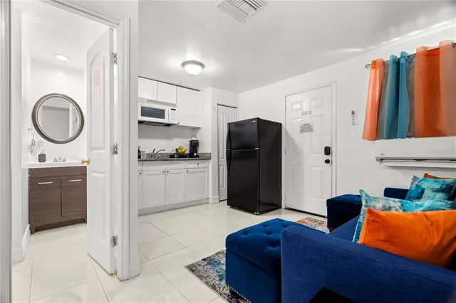 a spacious bathroom with a granite countertop sink and a mirror