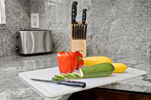 a bathroom with a granite countertop sink and mirror