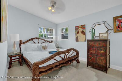 538 Riverside Drive Palm Beach Gardens, FL 33410 - Photo 14 of 52 a bedroom with a bed and a dresser in it
