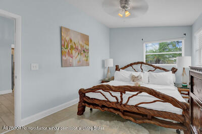 538 Riverside Drive Palm Beach Gardens, FL 33410 - Photo 15 of 52 a bedroom with a bed and a painting on the wall