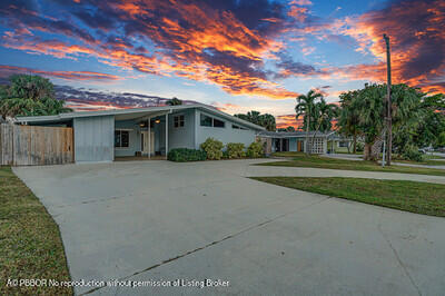 538 Riverside Drive Palm Beach Gardens, FL 33410 - Photo 40 of 52 a front view of a house with a garden