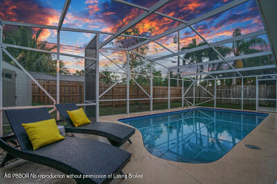 538 Riverside Drive Palm Beach Gardens, FL 33410 - Photo 47 of 52 a view of a swimming pool with a couches and wooden floor