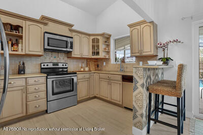 538 Riverside Drive Palm Beach Gardens, FL 33410 - Photo 10 of 52 a kitchen with stainless steel appliances a sink cabinets and a stove top oven