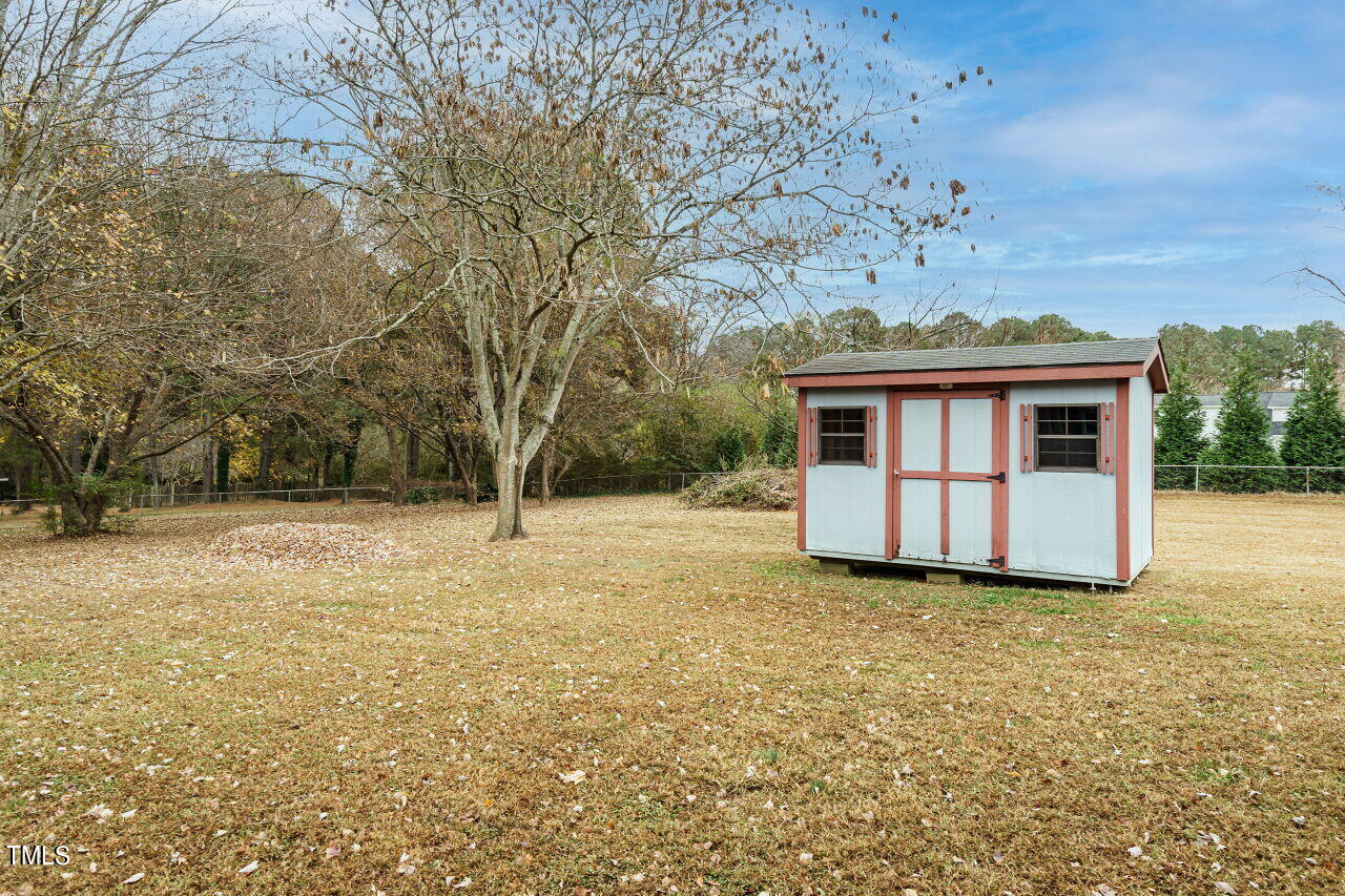 5917 Countryview Lane Raleigh, NC 27606 - Photo 27 of 43 This spacious and well-maintained shed offers convenient storage solutions for your outdoor equipment, tools, and more. It's a practical space that helps keep your property organized and clutter-free, allowing you to make the most of your outdoor living areas.