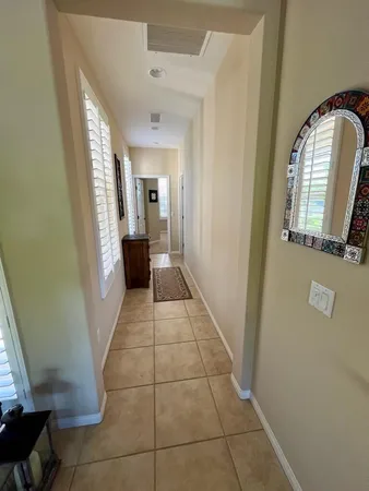 a view of a hallway to rooms and stairs