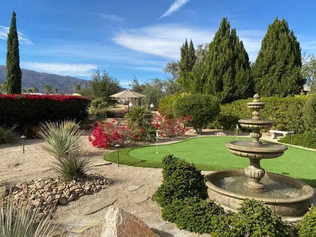 a backyard of a house with table and chairs