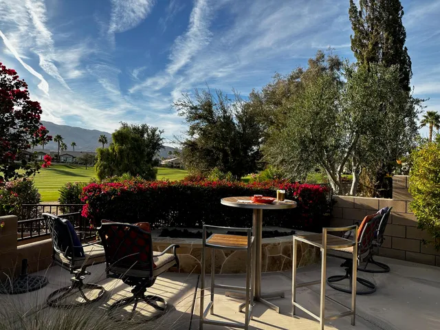 a view of a table and chairs in the garden