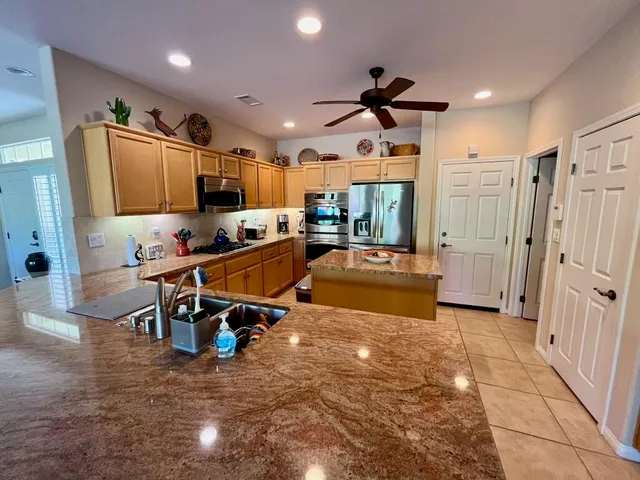 a living room with lots of furniture and a refrigerator