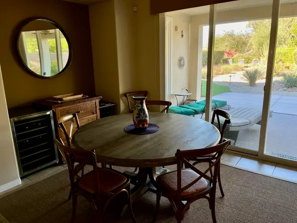a view of a dining room with furniture and window